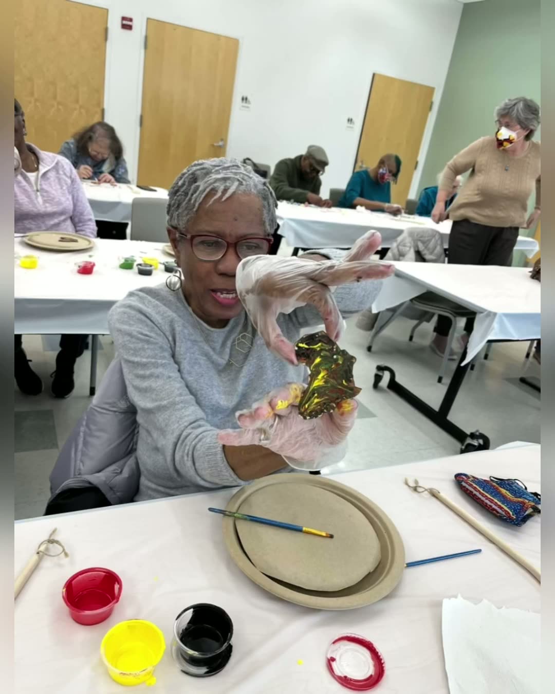 Senior attendee proudly presenting their creation